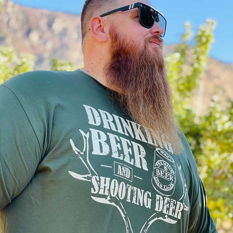 Drinking Beer and Shooting Deer Big Daddy Tee in Forest Green Man wearing the Big Daddy Drinking Beer Shooting Dear Graphic T-shirt in Forest Green