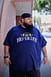 A man wearing the Big Daddy Crowned Navy Tee in size 6XL